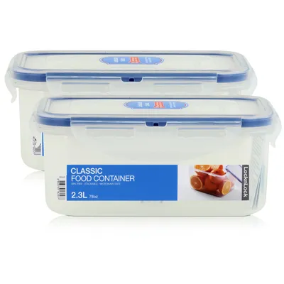 Two clear plastic food containers with blue lids are stacked on a white background.