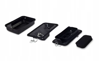 Four black plastic components of an air filter assembly are laid out on a white background.