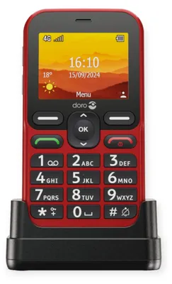 A red Doro Leva L10 mobile phone is shown in its charging dock against a white background.