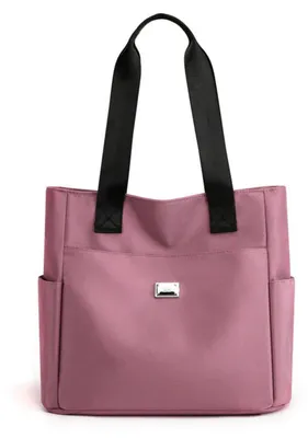 Rosa Stofftasche mit schwarzen Henkeln und zwei Seitentaschen, von vorne gezeigt