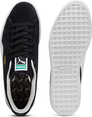 A top-down view of a pair of Puma Suede Classic shoes, showing the top of one shoe and the sole of the other.
