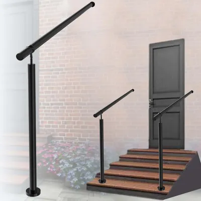 A black metal handrail is shown installed on a set of outdoor stairs leading to a door, with another handrail post visible on the left.