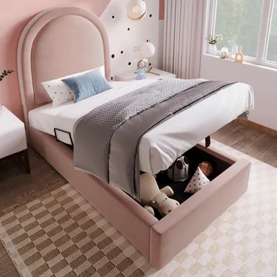 A child's bedroom with a pink upholstered bed, showing the storage compartment open.