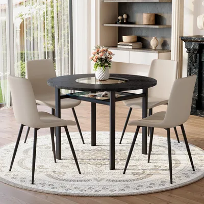Productafbeelding van STILVORA Eettafelset, rond, met 4 stoelen van Polyurethanmateriaal en comfortabele zitkussens. Ronde tafel, diameter 100 cm, met een zwarte houtlook. Eetset voor de woonkamer, in warmgrijs