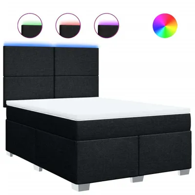 A black boxspring bed with a white mattress and a headboard with integrated LED lighting.
