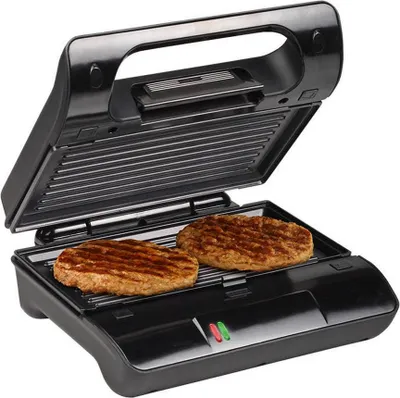 A black electric grill with two burgers cooking on it.