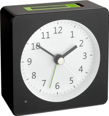 A black alarm clock with a white face and green accents is shown against a white background.