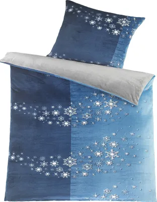 A folded duvet cover and pillowcase set with a snowflake pattern.