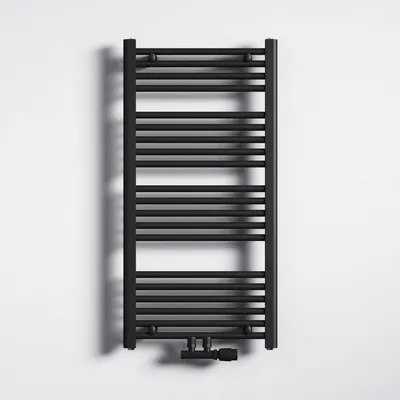 A black radiator is mounted on a white wall.