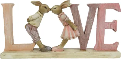 A decorative figurine of two rabbits kissing, forming the word 'LOVE'.