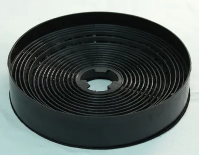A black circular carbon filter for a kitchen hood, coiled in a spiral pattern, is shown against a light gray and white background.