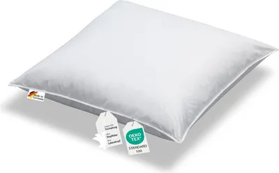 A white pillow with tags attached.