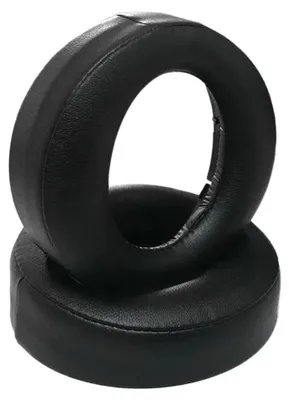 Two black ear pads for headphones are stacked on top of each other against a white background.