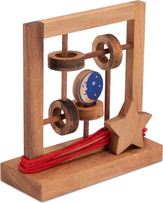 A wooden puzzle with rings, a moon and stars disk, and a star with red cord.