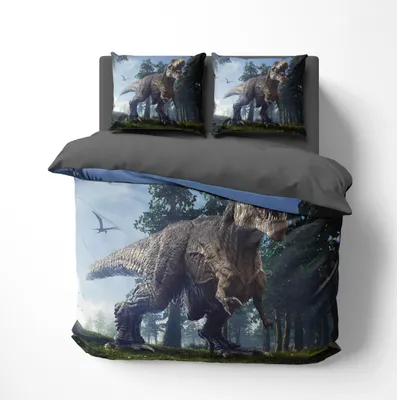 A bedding set with a dinosaur theme displayed on a bed.