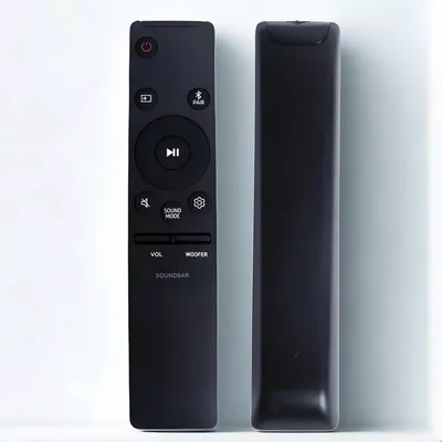 A black remote control for a soundbar is shown against a white and light gray background.