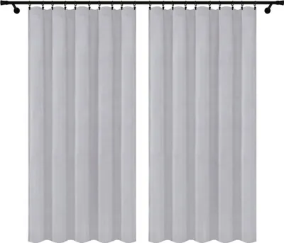 Two white curtains hanging on a black curtain rod against a white background.