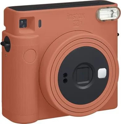 A close-up studio shot of a terracotta orange Fujifilm Instax Square SQ 1 instant camera against a white background.