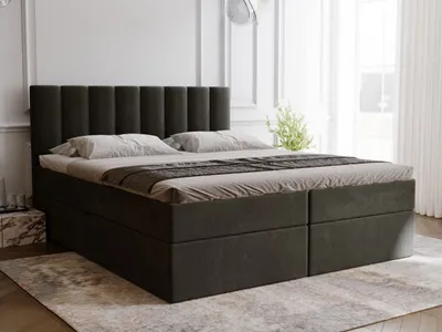 A bedroom scene with a bed and a rug.