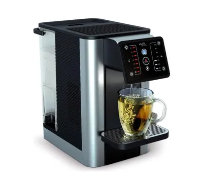 A close-up shot of a water dispenser/tea maker with a cup of tea being dispensed.