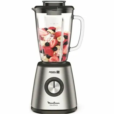 A blender filled with fruit on a white background.