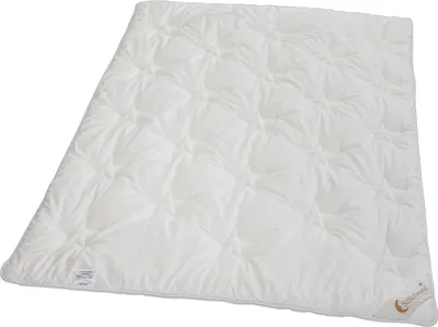 A white quilted duvet is laid out flat on a white background.