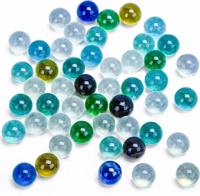 A collection of colorful glass marbles scattered on a white background.