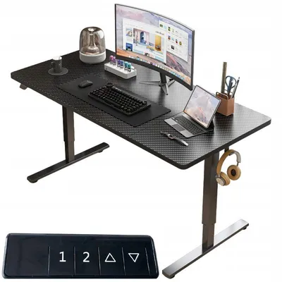 A black standing desk with a computer monitor, keyboard, laptop, and headphones.