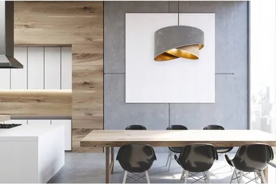 A modern dining room and kitchen area with a wooden table, chairs, and a large white artwork on a concrete wall.