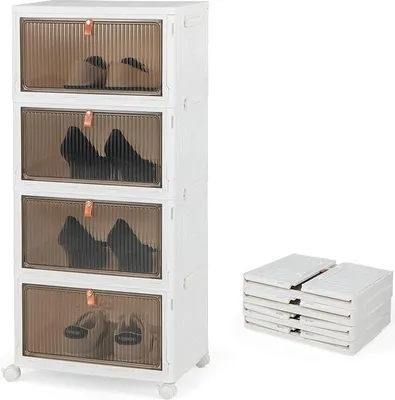 A white shoe cabinet with transparent doors, showing shoes inside, and a stack of foldable shoe boxes next to it.