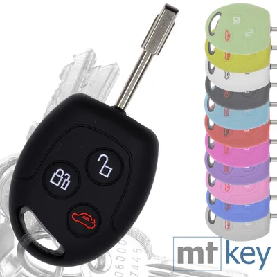 A black car key fob with three buttons and a keyring is shown on a white background, with a stack of colored key fob covers to the right. The text 'mt key' is visible in the bottom right corner.