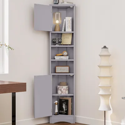 A gray corner cabinet with open shelves and two doors, displaying various decorative items and books.