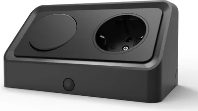 A black electrical outlet with a circular indentation and a standard European socket.