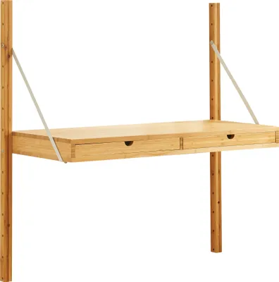 A wall-mounted desk made of bamboo with two drawers, supported by metal brackets and attached to vertical wooden poles.