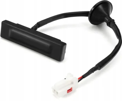 A black car trunk handle button with a wire and connector is shown against a white background.