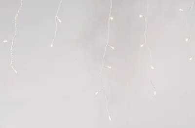 Icicle lights hanging against a light background.