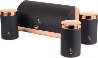 A set of kitchen containers and a bread bin with copper accents.