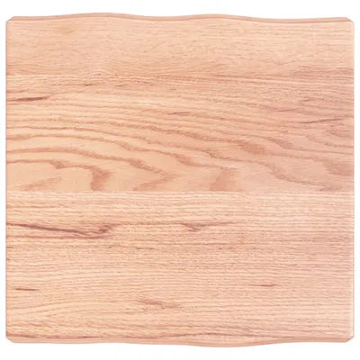 A close-up view of a wooden tabletop with natural wood grain and a slightly wavy edge.