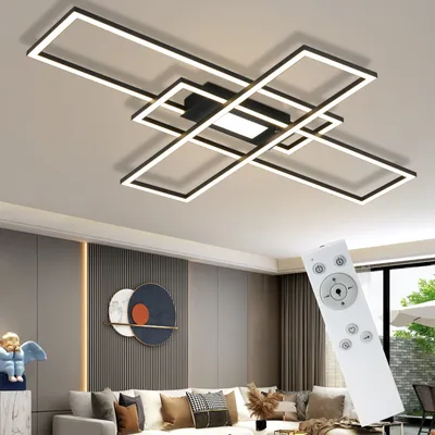 A modern geometric LED ceiling light fixture with a remote control.