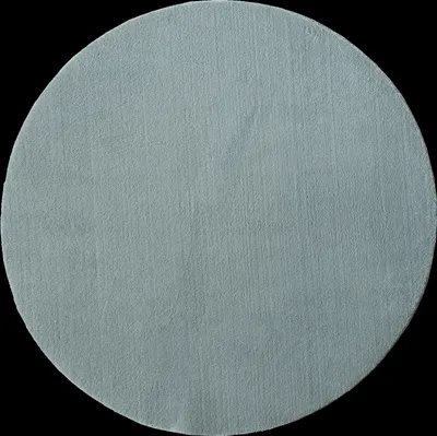 A circular rug on a black background.
