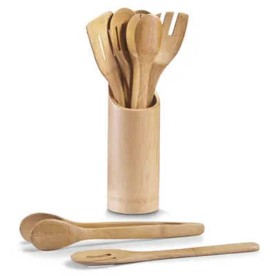 A set of bamboo kitchen utensils in a holder, with a pair of tongs and a slotted spoon in the foreground.