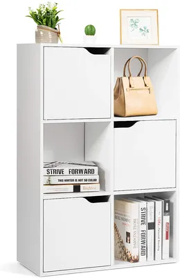 A white cube storage unit with various items on and inside it.