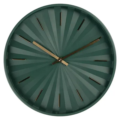 A close-up view of a green wall clock with a sunburst pattern and gold hands.