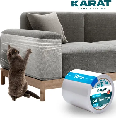 A cat scratching a sofa arm, with a roll of anti-scratch tape next to it.