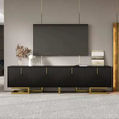 A modern living room with a black TV stand and a large flat-screen TV mounted above it.