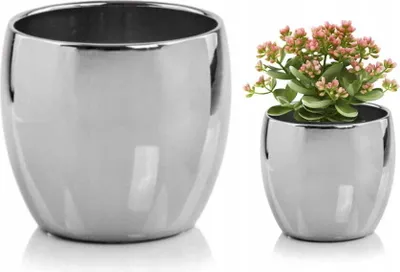 Two silver ceramic pots, one empty and one with a small plant.