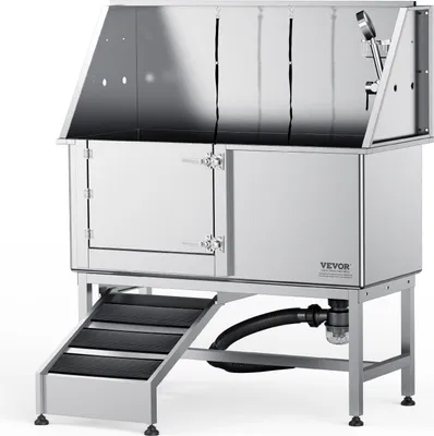 A professional product shot of a stainless steel dog grooming tub with stairs and a shower head.