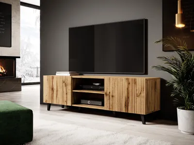 A modern living room with a TV stand, fireplace, and plant.