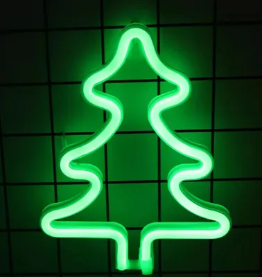 A green neon Christmas tree light against a dark grid background.