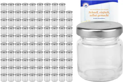A collection of small glass jars with silver lids, and one jar shown individually with a small booklet behind it.